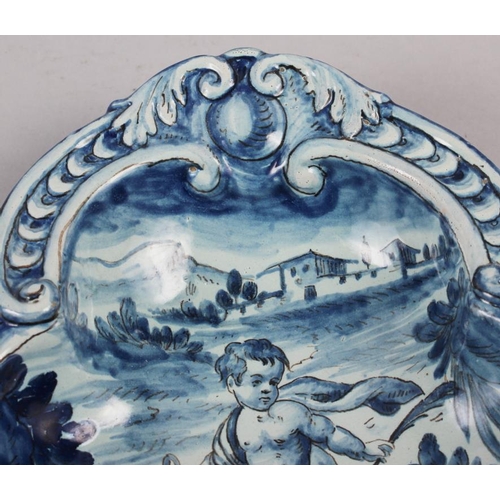 48 - A pair of 19th century Cantagalli blue and white painted dishes with putto decoration (restored)