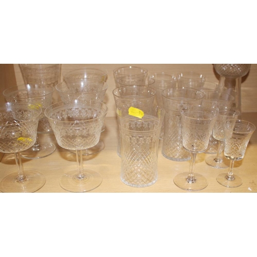 59 - A part suite of Edwardian drinking glasses with cut and engraved decoration, and a thistle-shaped de... 