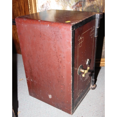 704 - An early 20th century safe with key, 13