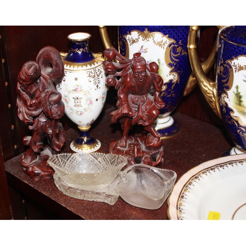 86 - A pair of Coalport two-handled vases with covers, decorated panels with birds and insects on a blue ... 