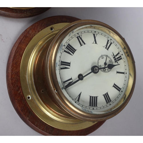 162 - A brass cased bulkhead clock with subsidiary seconds dial and Roman numerals, 7 1/2