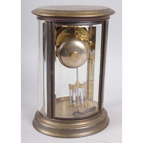 168 - An oval brass cased four glass mantel clock with white enamel dial and Roman numerals