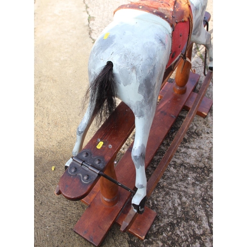 237 - An early 20th century Ayres type carved wood rocking horse, 44