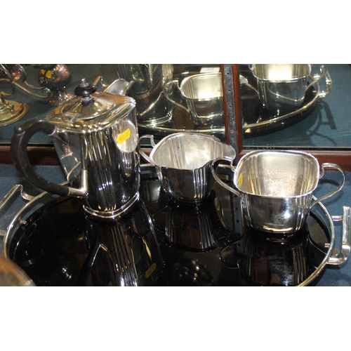 312 - An Art Deco silver plated four-piece tea and coffee set with black coloured glass and a plated galle... 