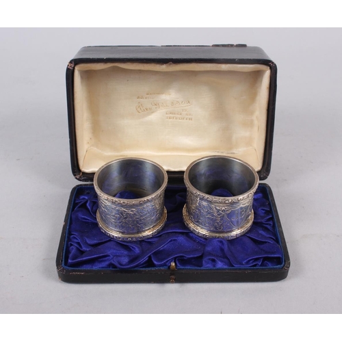 344 - A pair of silver napkin rings with engraved decoration, in box, 2oz troy approx