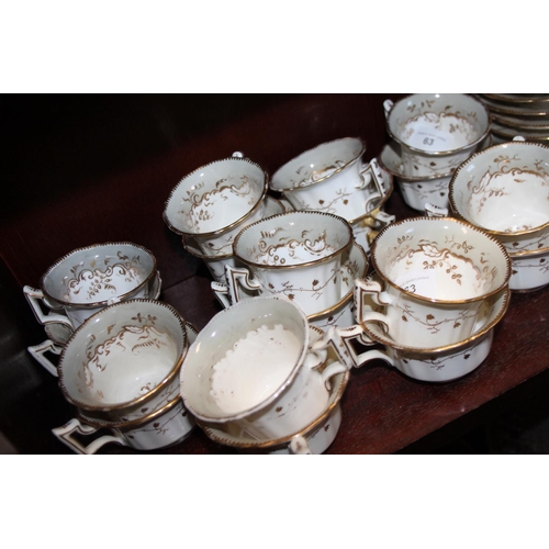 63 - A Rockingham porcelain tea service, decorated weeping gilt foliage, comprising eleven teacups, eleve... 