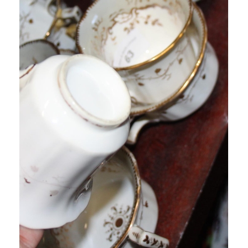 63 - A Rockingham porcelain tea service, decorated weeping gilt foliage, comprising eleven teacups, eleve... 