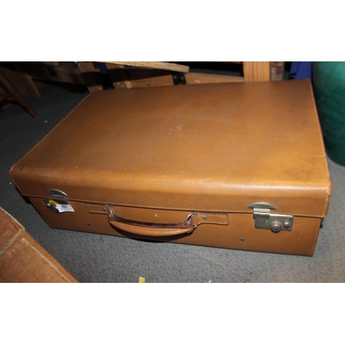 255 - A brown leather suitcase