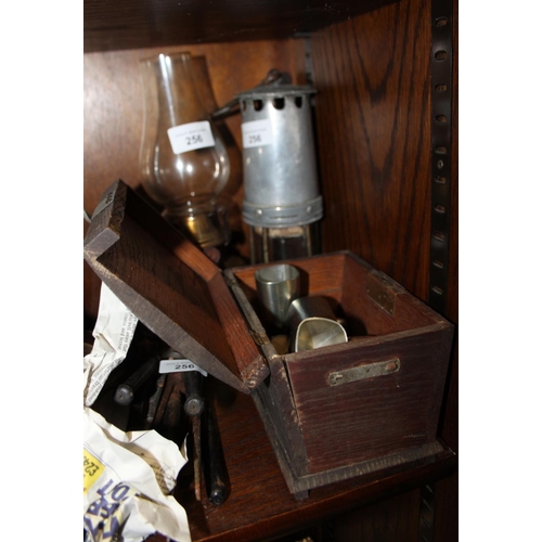 256 - A miner's lamp, a brass oil lamp, four pewter shot glasses, a number of sets of curling tongs and a ... 