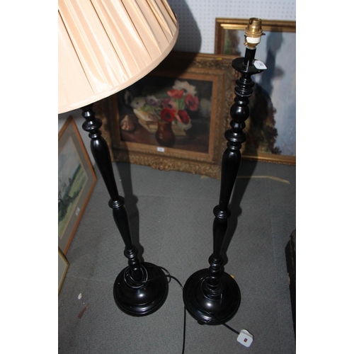 291 - A pair of ebonised standard lamps with turned columns, on circular bases