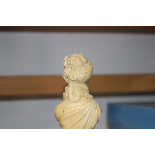 142 - A 19th century carved ivory portrait bust of Marie Antoinette, on turned column, 4 3/4