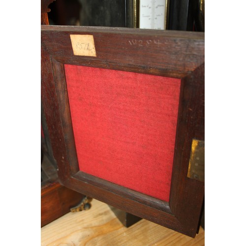 170 - An oak cased mantel clock with brass relief decoration, on brass scrolled supports, 16 1/2