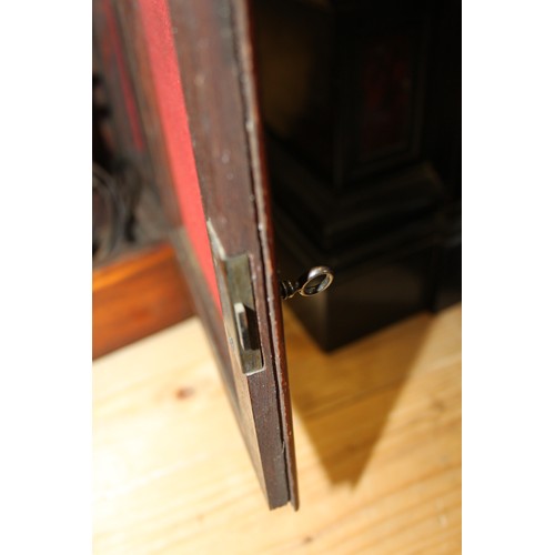 170 - An oak cased mantel clock with brass relief decoration, on brass scrolled supports, 16 1/2