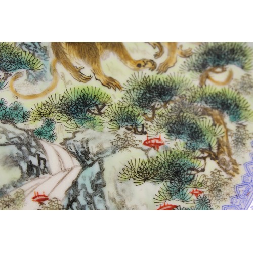 124 - A pair of Chinese plates, decorated monkeys in a landscape with character marks to base, 10 1/4