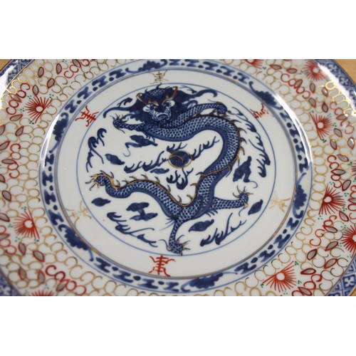 124 - A pair of Chinese plates, decorated monkeys in a landscape with character marks to base, 10 1/4