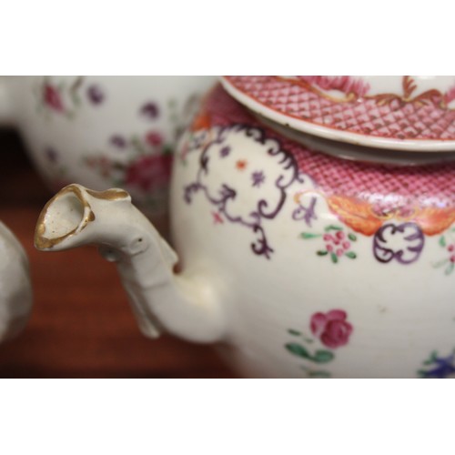 128 - A Chinese export teapot with floral decoration and pink borders, and seven other teapots