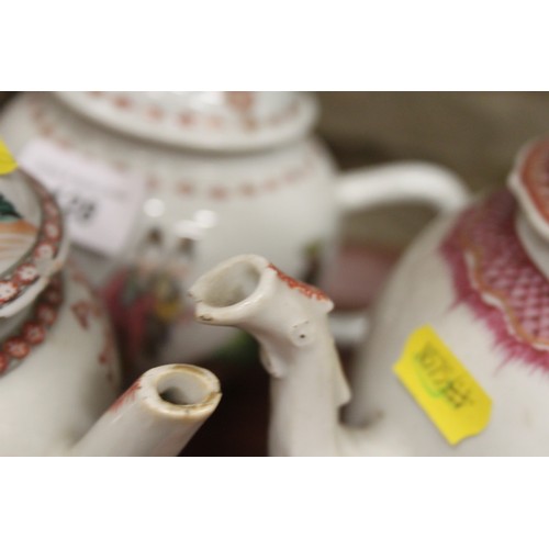 128 - A Chinese export teapot with floral decoration and pink borders, and seven other teapots