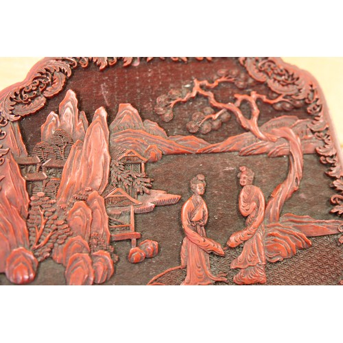 145 - A Chinese carved cinnabar lacquered box, decorated figures in a garden