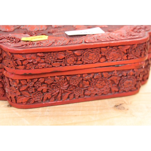 145 - A Chinese carved cinnabar lacquered box, decorated figures in a garden