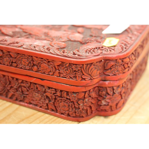 145 - A Chinese carved cinnabar lacquered box, decorated figures in a garden