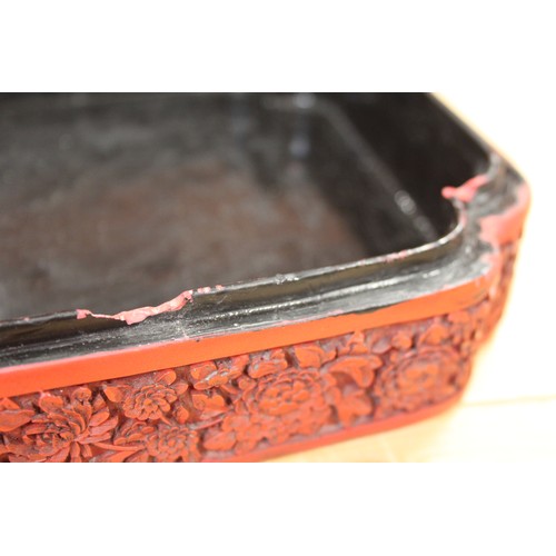 145 - A Chinese carved cinnabar lacquered box, decorated figures in a garden