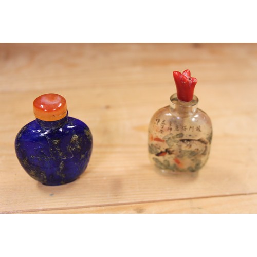 153 - A Chinese carved lapis lazuli snuff bottle, decorated with a bird on a branch to one side and figure... 