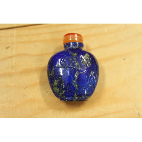 153 - A Chinese carved lapis lazuli snuff bottle, decorated with a bird on a branch to one side and figure... 