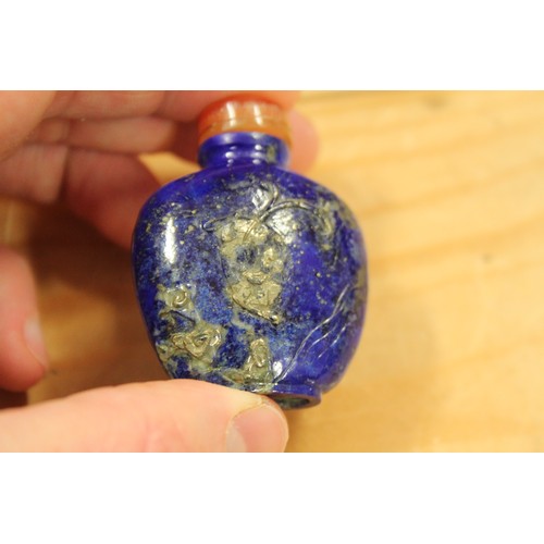 153 - A Chinese carved lapis lazuli snuff bottle, decorated with a bird on a branch to one side and figure... 