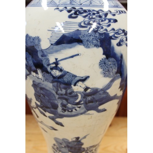 116 - A 19th century Chinese blue and white baluster vase, decorated warriors on horseback, 19 1/2