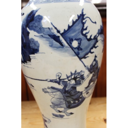 116 - A 19th century Chinese blue and white baluster vase, decorated warriors on horseback, 19 1/2