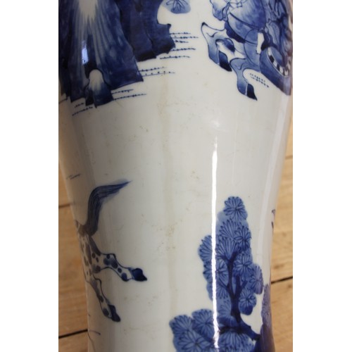 116 - A 19th century Chinese blue and white baluster vase, decorated warriors on horseback, 19 1/2