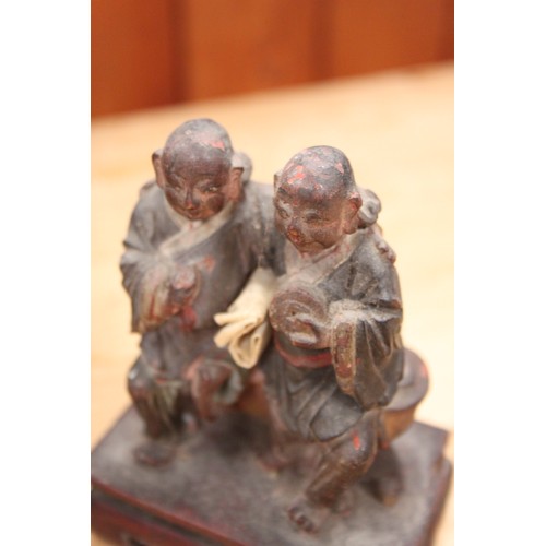 143 - A quantity of Chinese carved figures, including a figure of Buddha and an abacus