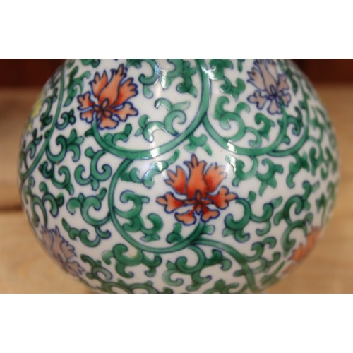 121 - A Chinese bulbous vase with vine and floral decoration, 8