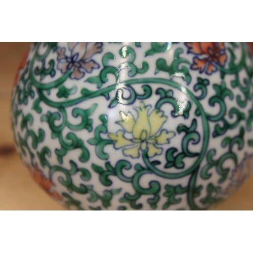 121 - A Chinese bulbous vase with vine and floral decoration, 8