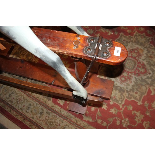 237 - An early 20th century Ayres type carved wood rocking horse, 44