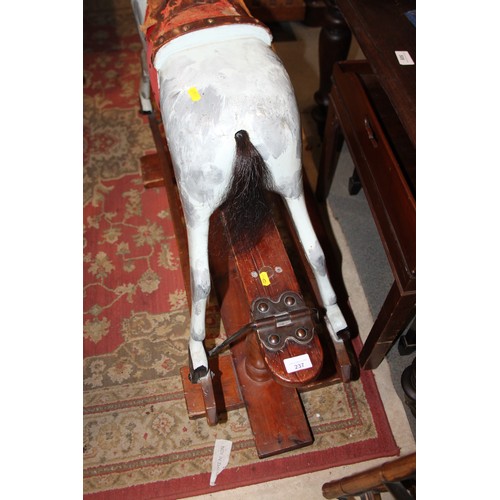 237 - An early 20th century Ayres type carved wood rocking horse, 44