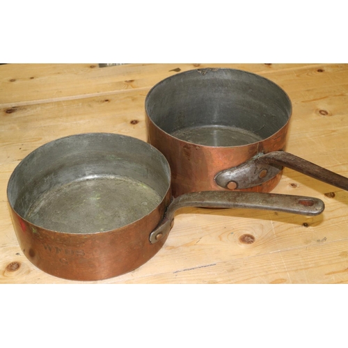 124 - Two 19th century copper saucepans with wrought iron handles, 10