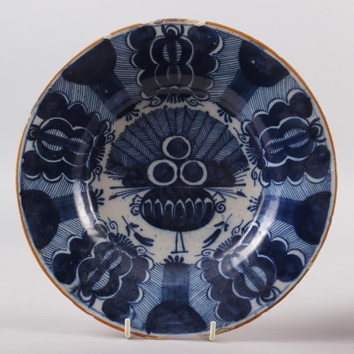 13 - An 18th century Delft plate with vase of flowers decoration, 8 1/2