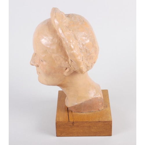 172 - A 1930s terracotta portrait bust of a woman with a long plait, 13