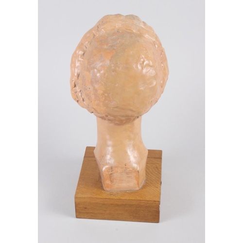 172 - A 1930s terracotta portrait bust of a woman with a long plait, 13