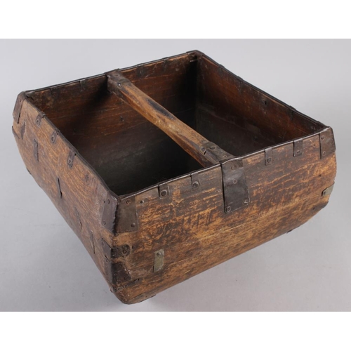 178 - A square wooden vessel with metal fittings and carrying handle, 13 1/2