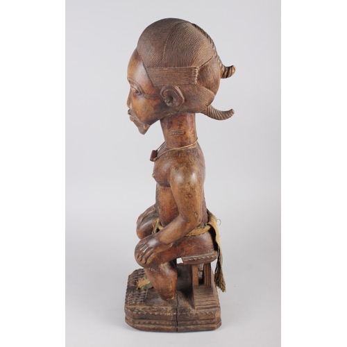 192 - A West African carved hardwood seated ancestor figure, 25