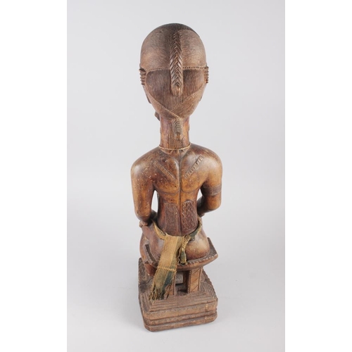 192 - A West African carved hardwood seated ancestor figure, 25