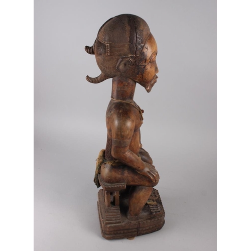 192 - A West African carved hardwood seated ancestor figure, 25