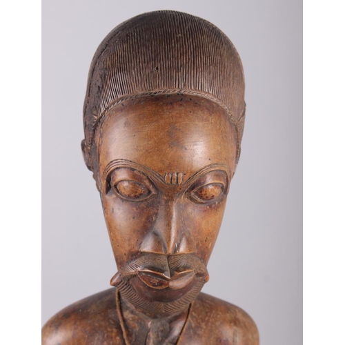 192 - A West African carved hardwood seated ancestor figure, 25