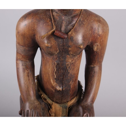 192 - A West African carved hardwood seated ancestor figure, 25