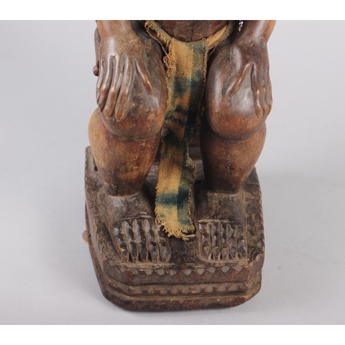 192 - A West African carved hardwood seated ancestor figure, 25