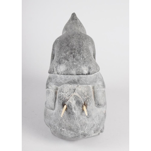 198 - An Inuit hardstone model of a man on a walrus, 8