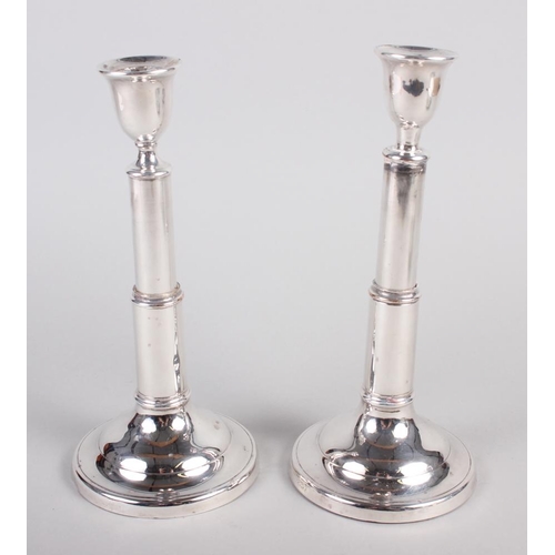 235 - A pair of silver plated adjustable candlesticks, on circular bases, stamped 