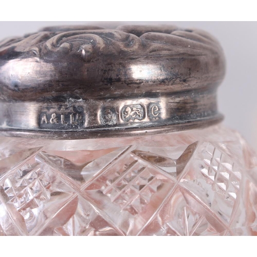 268 - A silver cigarette box and four cut glass and silver mounted dressing table jars